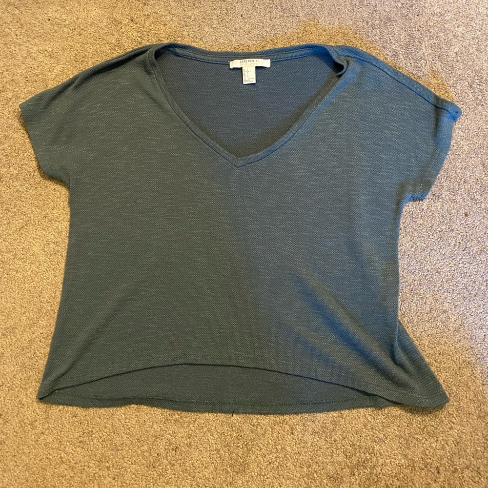 Cropped but can be tucked into high rise pants
